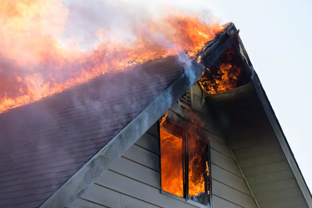 Ash Removal . closeup fire in window and roof.