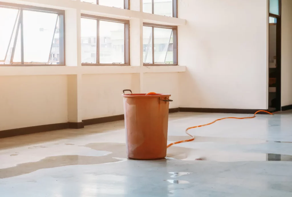 Restoring Water-Damaged Content. orange bin in water damaged room.